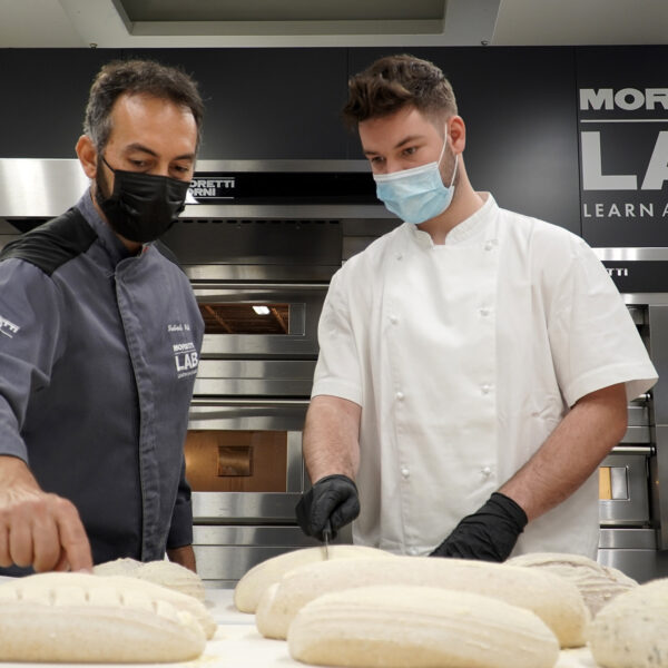 Corporate chef cutting bread